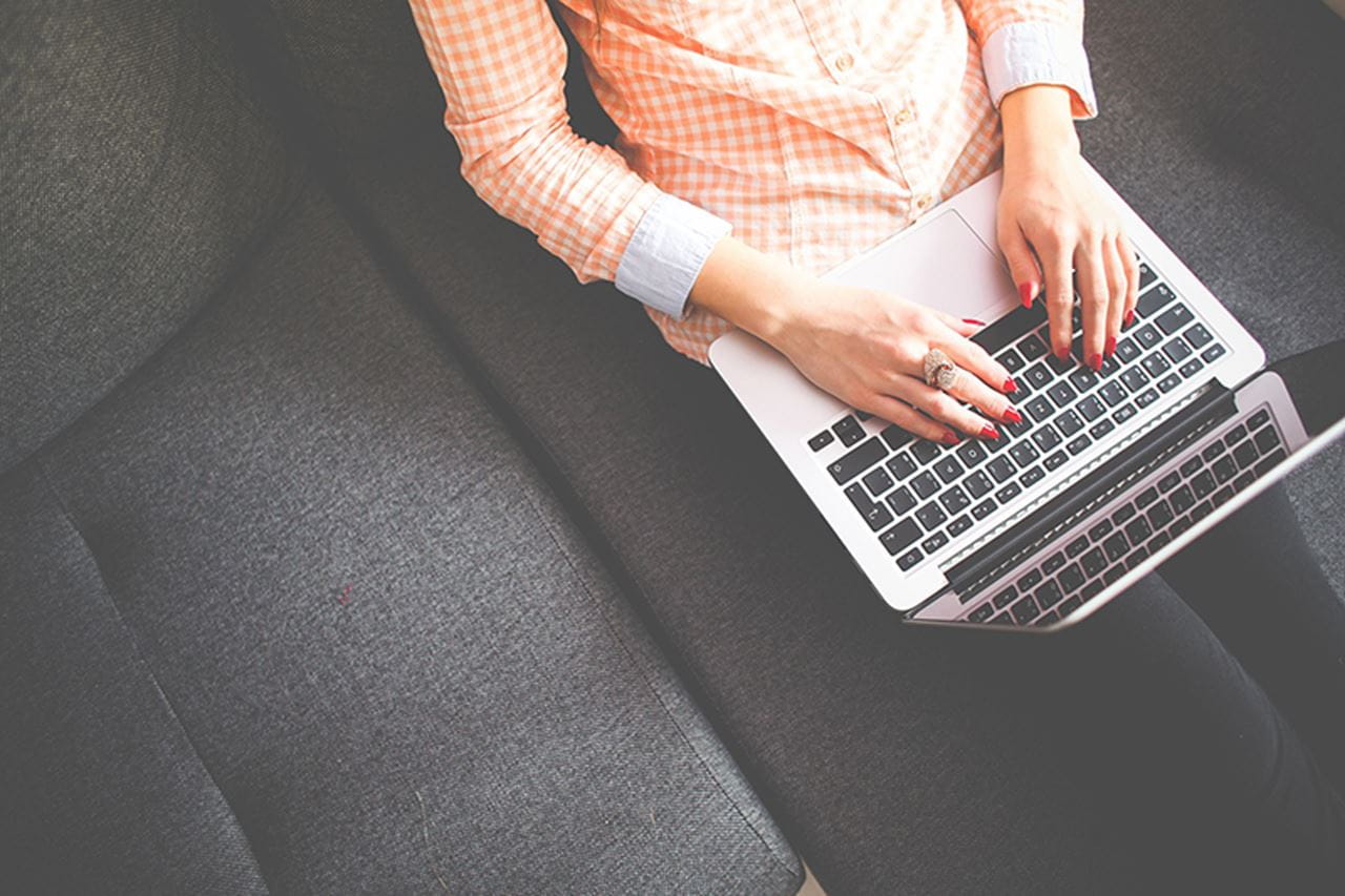 Woman typing on a lap top computer