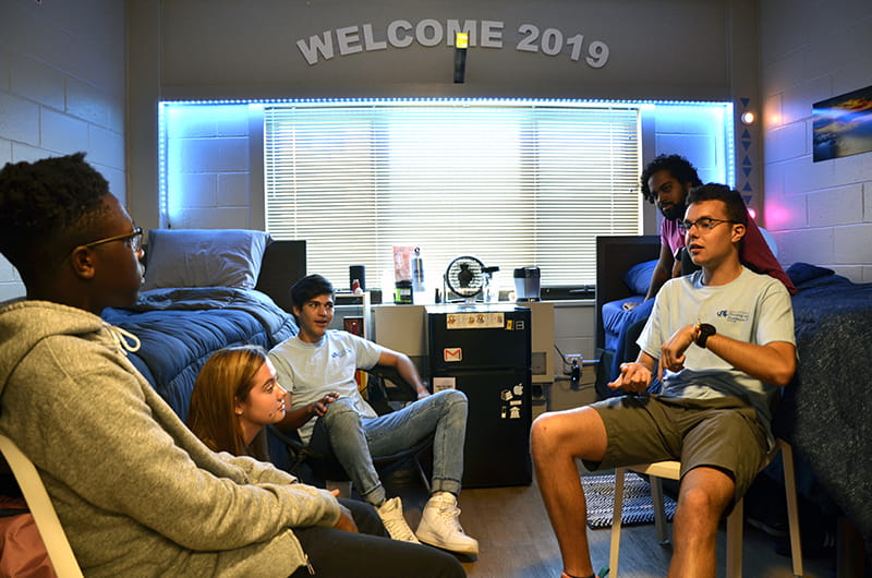First-year students and resident assistants hang out in a dorm room in Drexel's Bentley Hall.