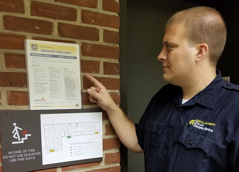 Fire and Emergency Services Specialist Christopher Platz reviews an Emergency Procedures Bulletin.
