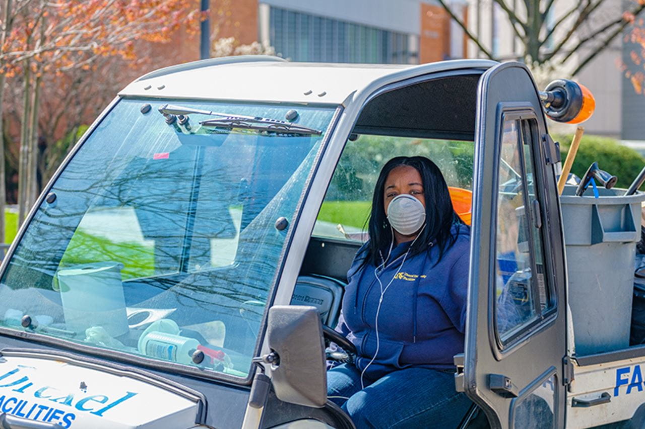A Drexel Facilities employee at the Mario statue on 33rd and Market streets.