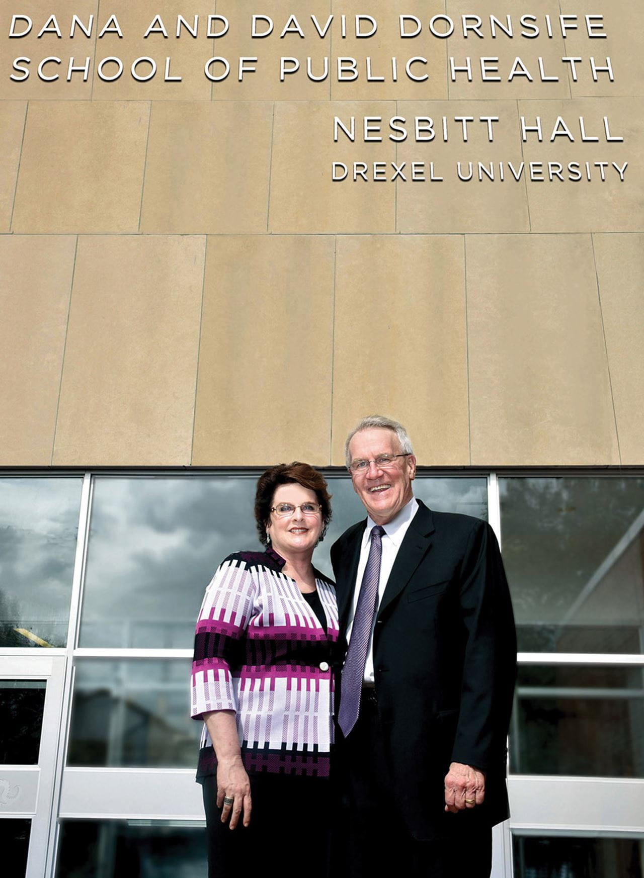 Dana and David Dornsife standing in front of the Dornsife School of Public Health