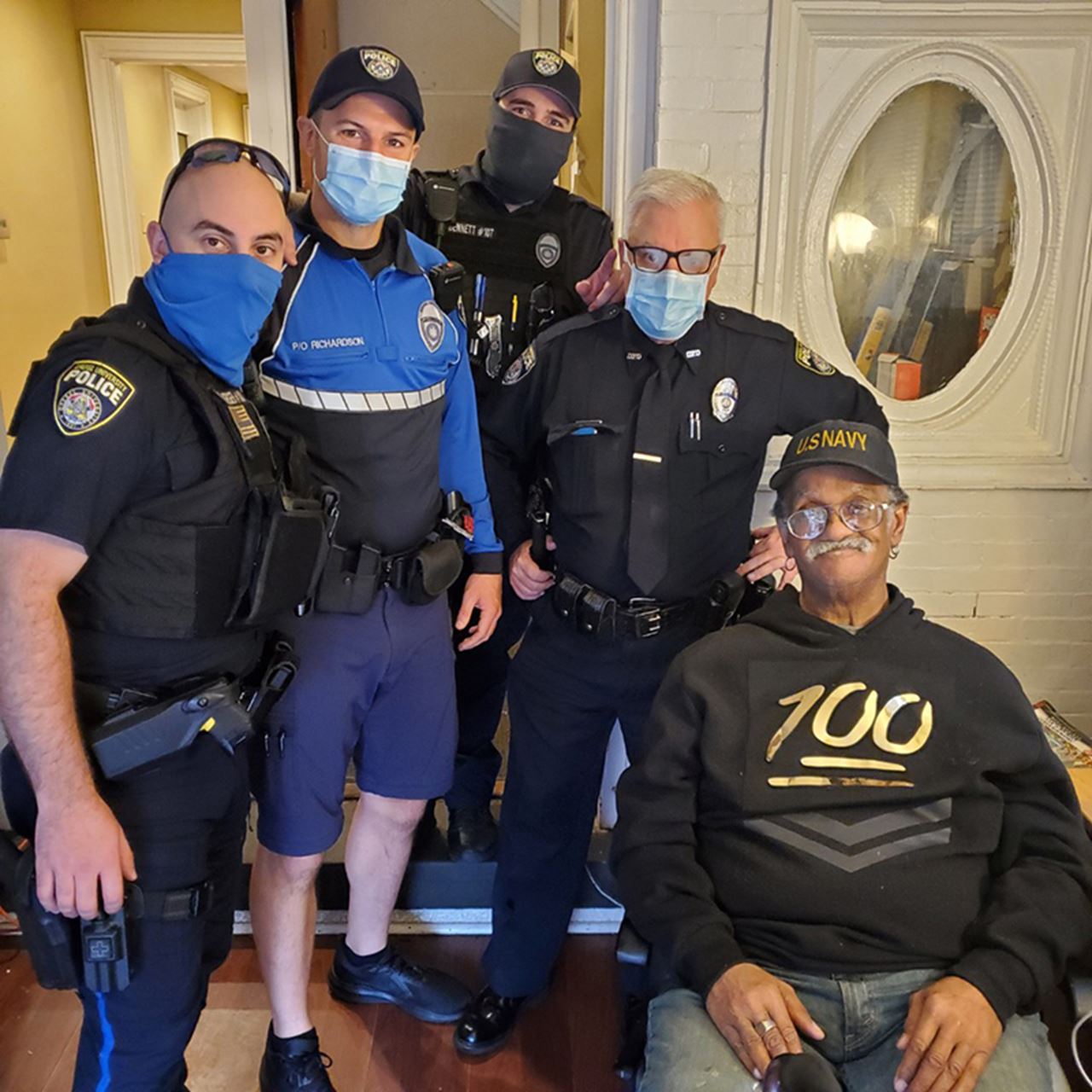 Officers John Joerger, Matt Richardson, Ryan Bennett and Morgan Meehan with U.S. Navy Veteran Ronald Blakey at 3209 Baring.