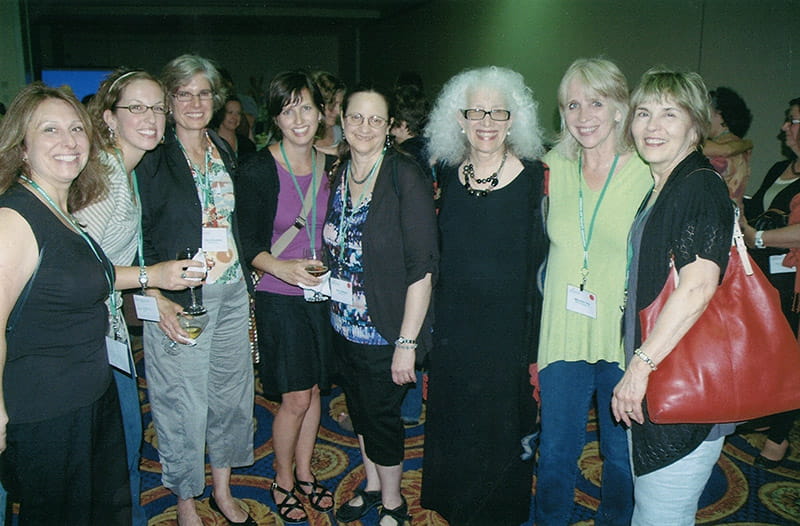 Founding director of the Creative Arts Therapy PhD Program Nancy Gerber, PhD, third from right); former faculty member Betty Hartzell, PhD (far right); current doctoral student Kathryn Snyder (fourth from left); and alumni from the department's MA program in an undated photo from the 2000s. Photo courtesy Sherry Goodill, PhD.