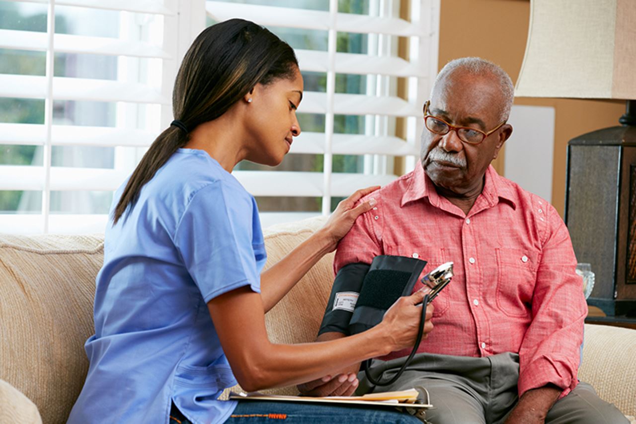 Nurse take patient's blood pressure
