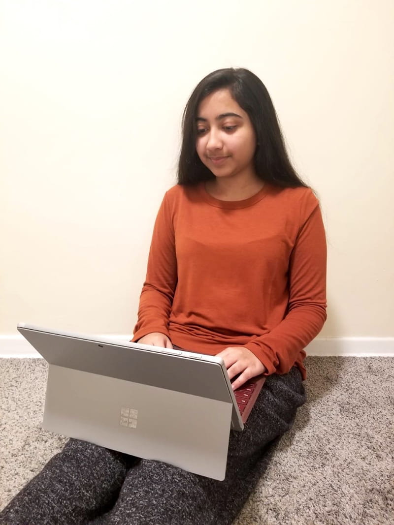 Sanjana Ahmed, a rising second-year accounting student formerly in the first-year exploratory studies major, takes a Zoom call while sitting on the floor of her home.
