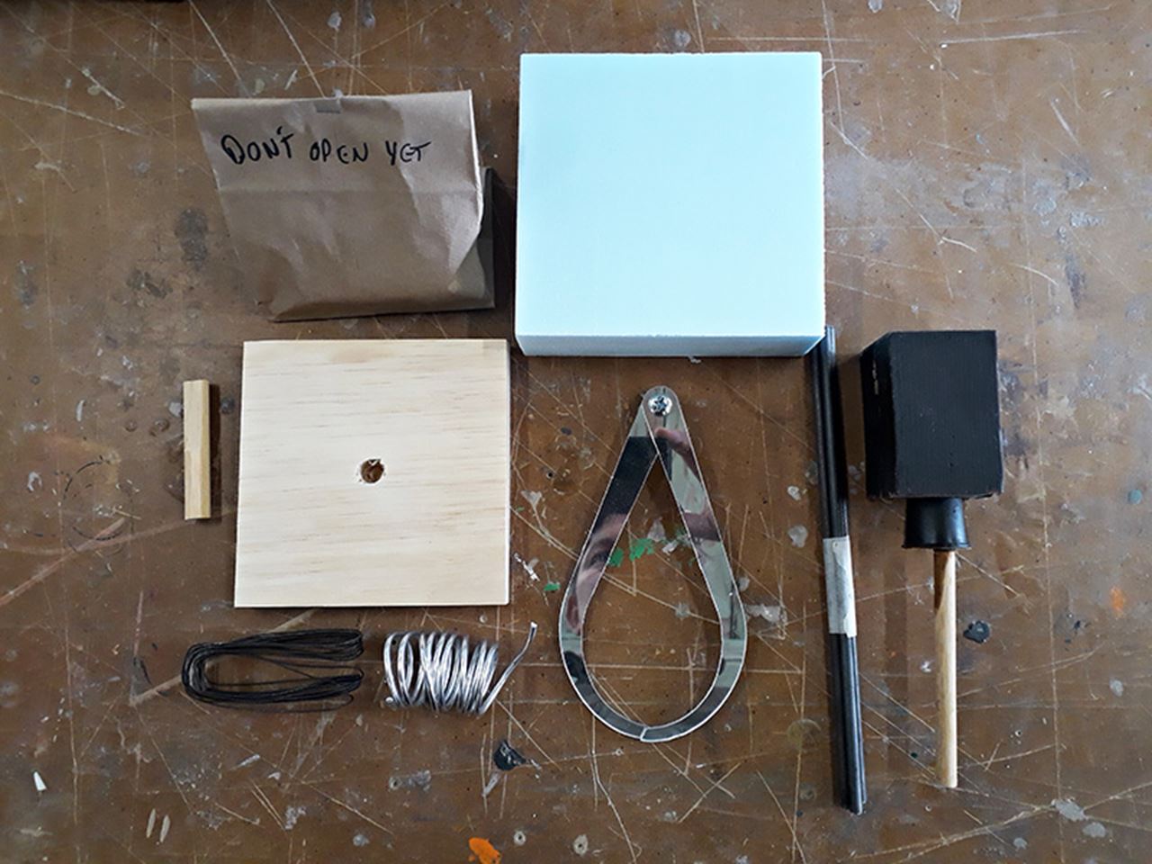 Professor Lewis Colburn collected these materials to send to his sculpture students before campus closed in March. These spring term Sculpture I care packages included blocks of wax, pieces of wood and wire, and finally, one of the mechanical components of a spray paint gun that Colburn had in his studio.