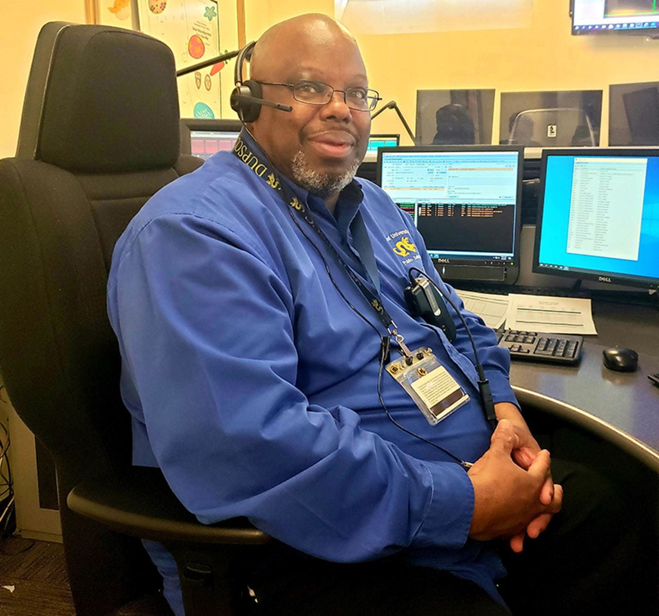 Henry Dunbar seated in front of a computer.