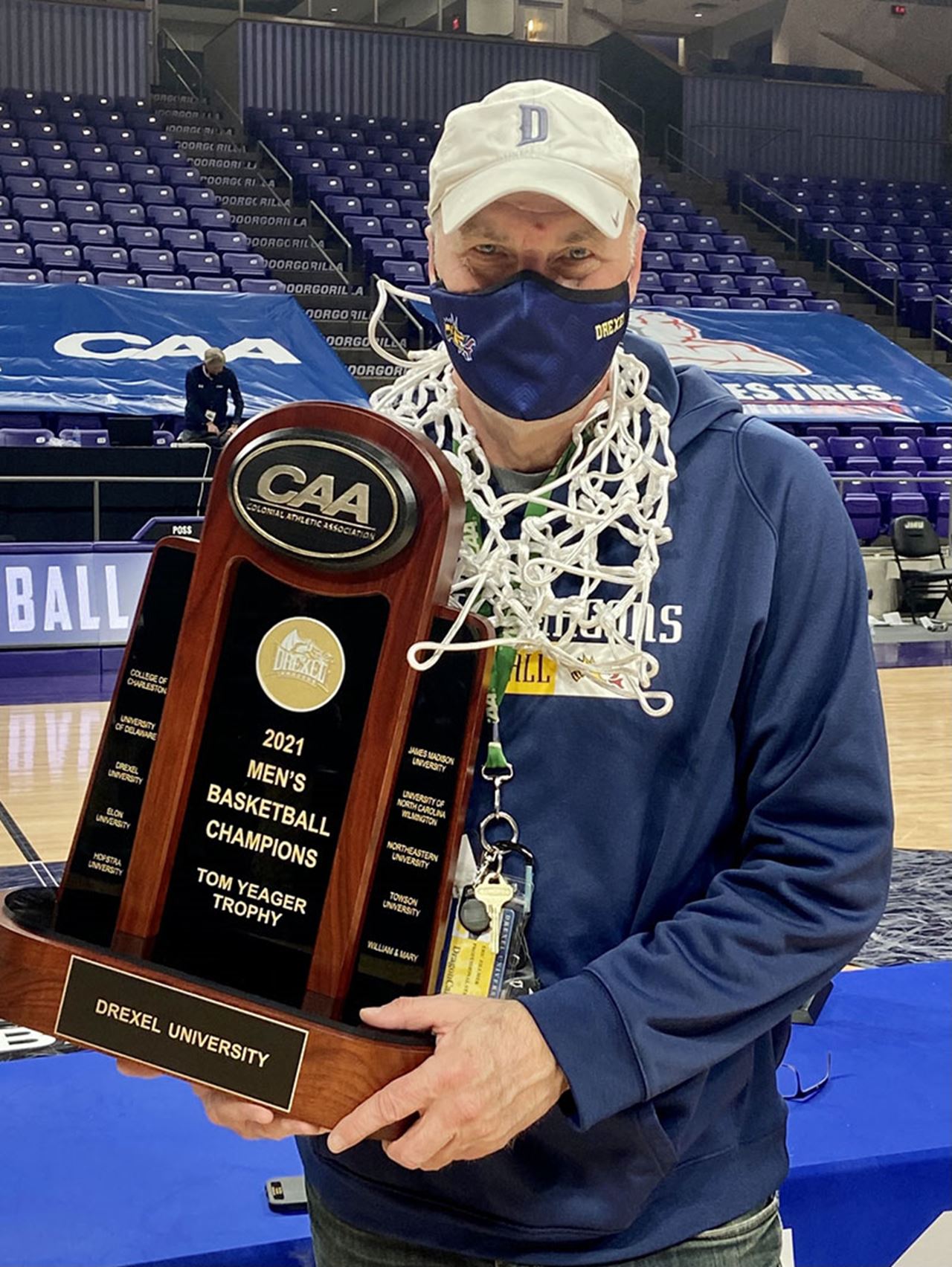 Eric Zillmer and the CAA men's basketball championship trophy.