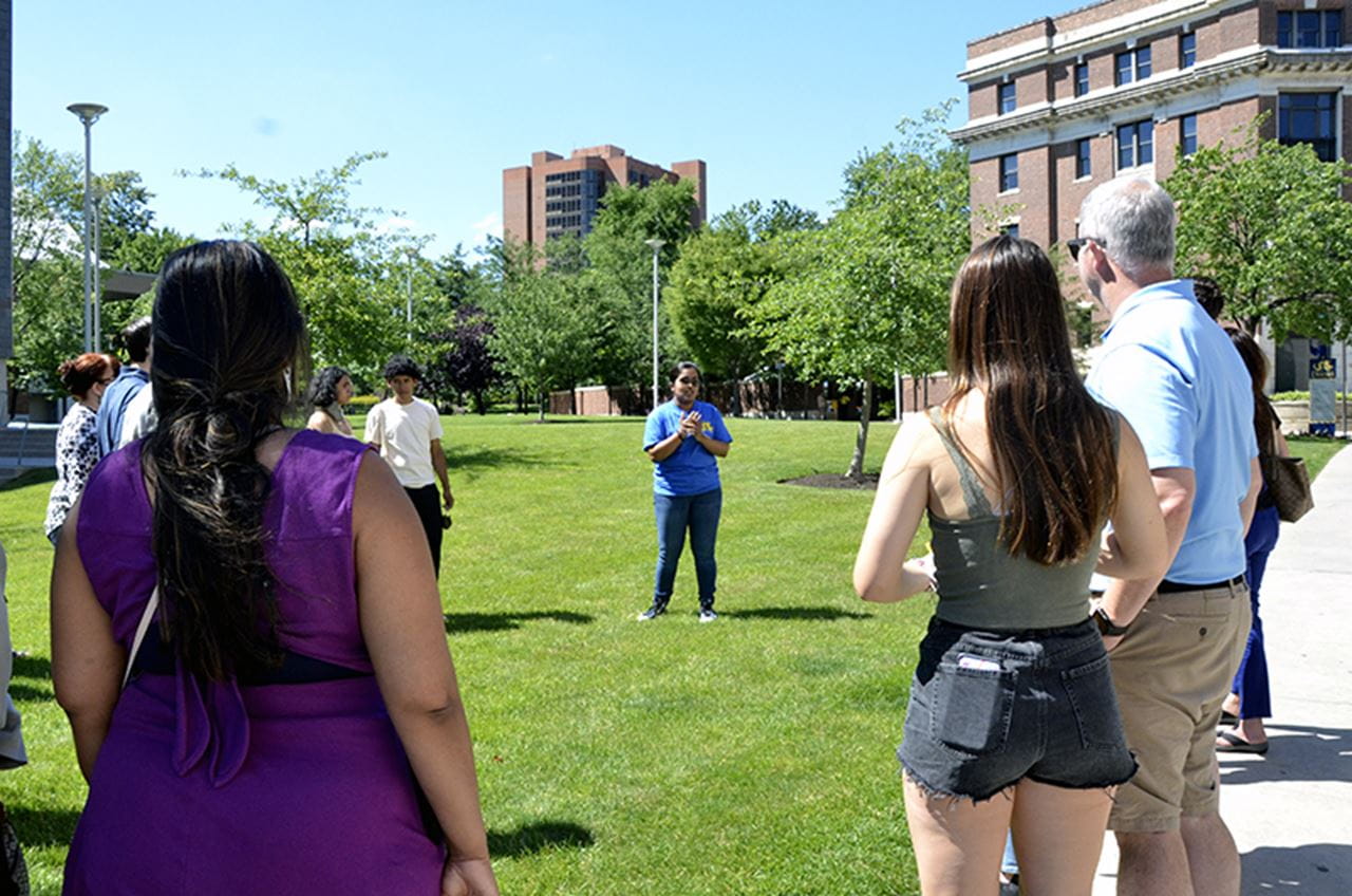 Drexel student Esta Jacob explaining resident and student life during a campus tour for prospective students.