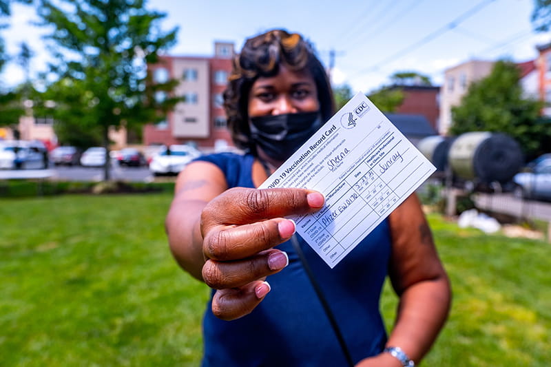 Sheena Coleman, 40, of Powelton Village, received her first dose of the Pfizer vaccine at a walk-up clinic at the Dornsife Center for Neighborhood Partnerships on May 27.