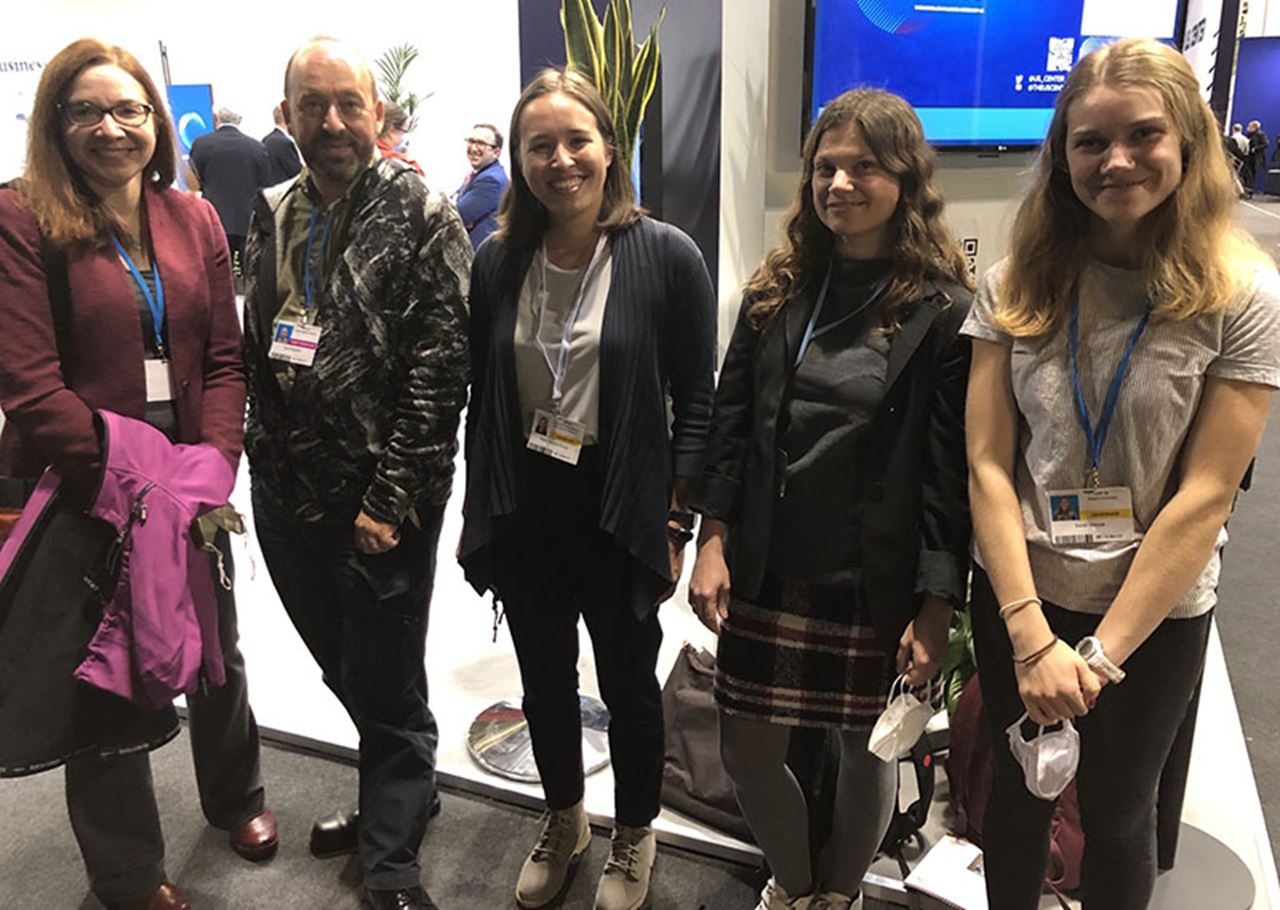 A group of climate scientists and students at COP26. From left to right: Texas Tech University Paul Whitfield Horn Distinguished Professor and Endowed Chair in Public Policy and Public Law Katherine Hayhoe, PhD; Director of the NASA Goddard Institute for Space Studies Gavin Schmidt, PhD; Princeton University PhD candidate Maya Chung; and, far right, Sarah Wetzel. Photo courtesy Sarah Wetzel.