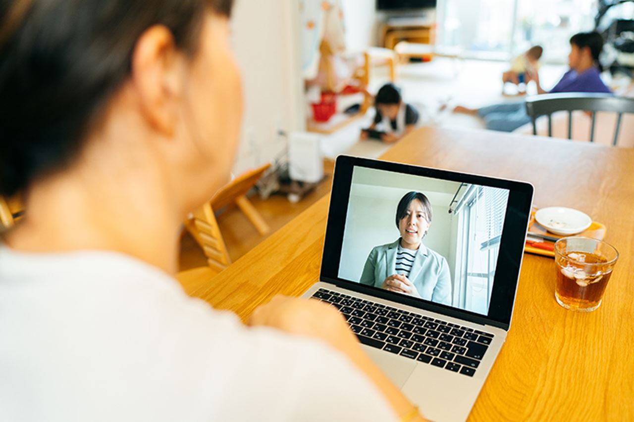 Woman video chatting with a woman on the laptop.