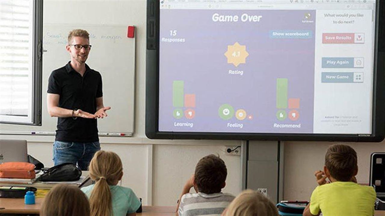 teacher talking to students in the classroom