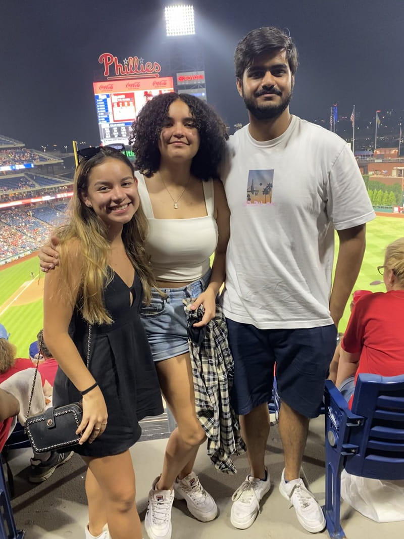 Paula Garcia (left) poses with fellow second-year Global Scholars, Nathalia Gomez and Ahmed Azhar, at a Phillies game trip sponsored by Drexel's STAR Scholars program in summer 2021.