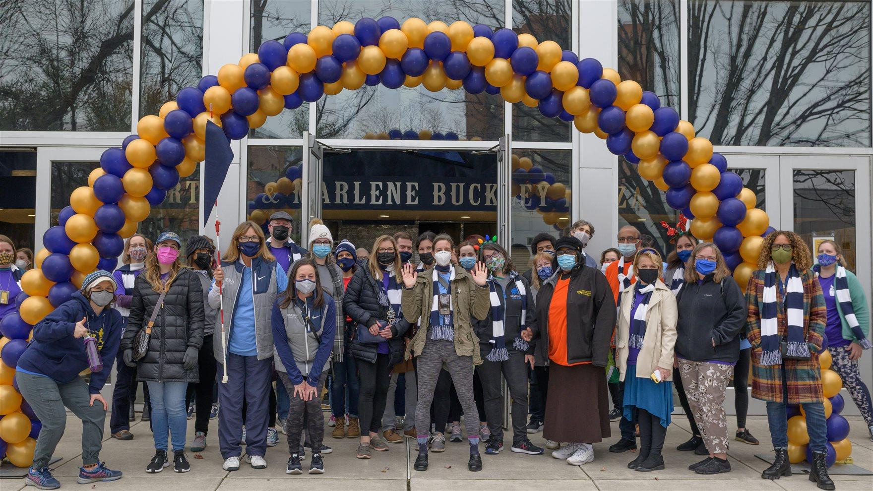 Faculty and professional staff posing outside of the Drexel Recreation Center at the 2021 Employee Olympics — A Healthier U event — on Dec. 15, 2021. Monica Fauble, wellness consultant, who oversees A Healthier U, is pictured center, with hands up. Photo credit: Hanbit Kwon