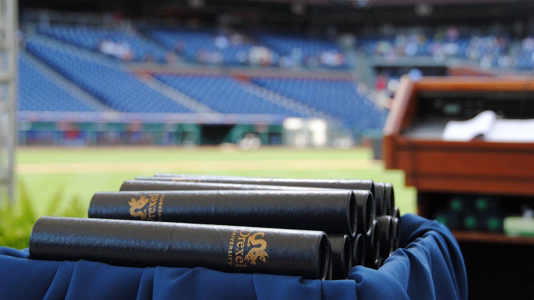 Diplomas stacked in front of the podium at Citizens Bank Park.