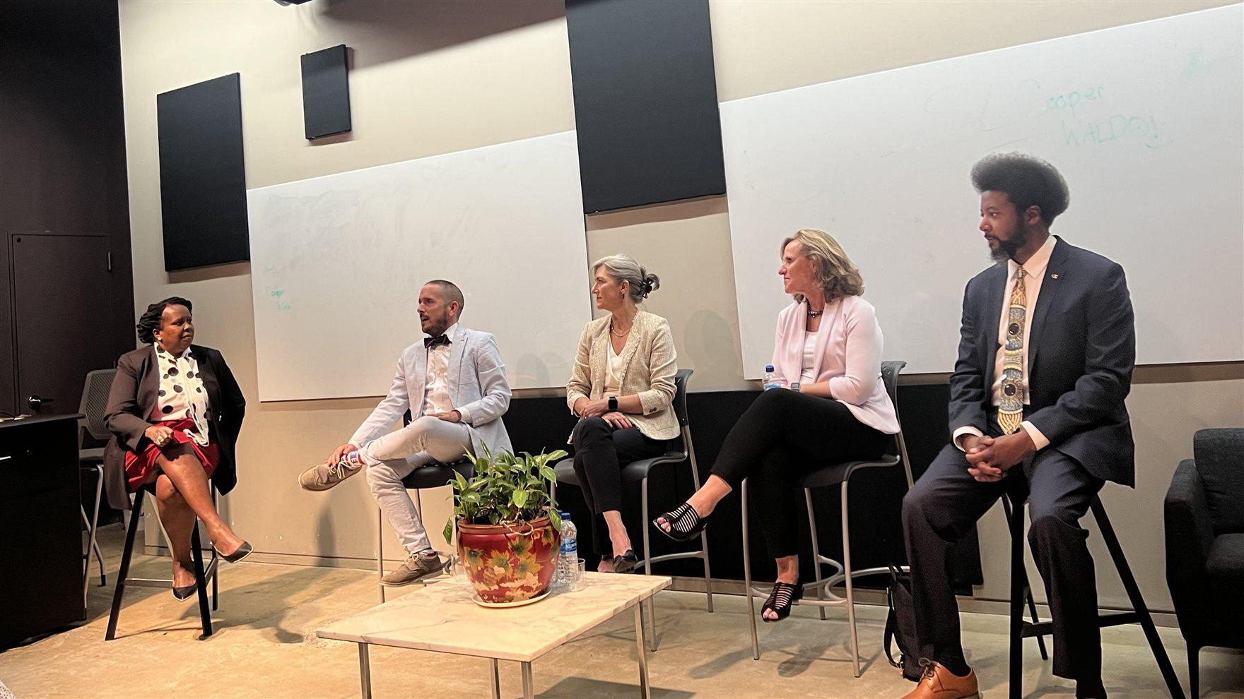A seated panel of higher education experts. 