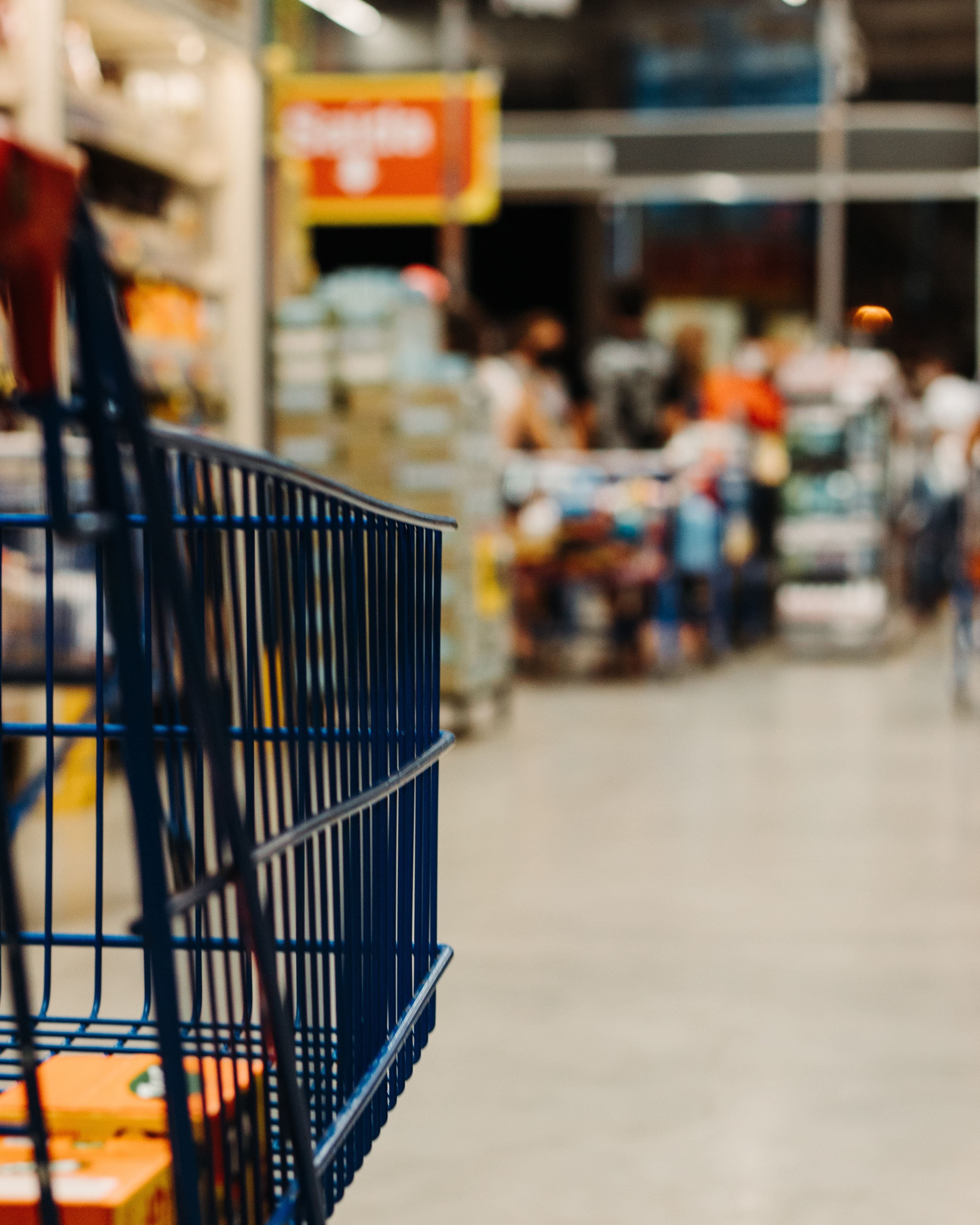 Supermarket cart in aisle.