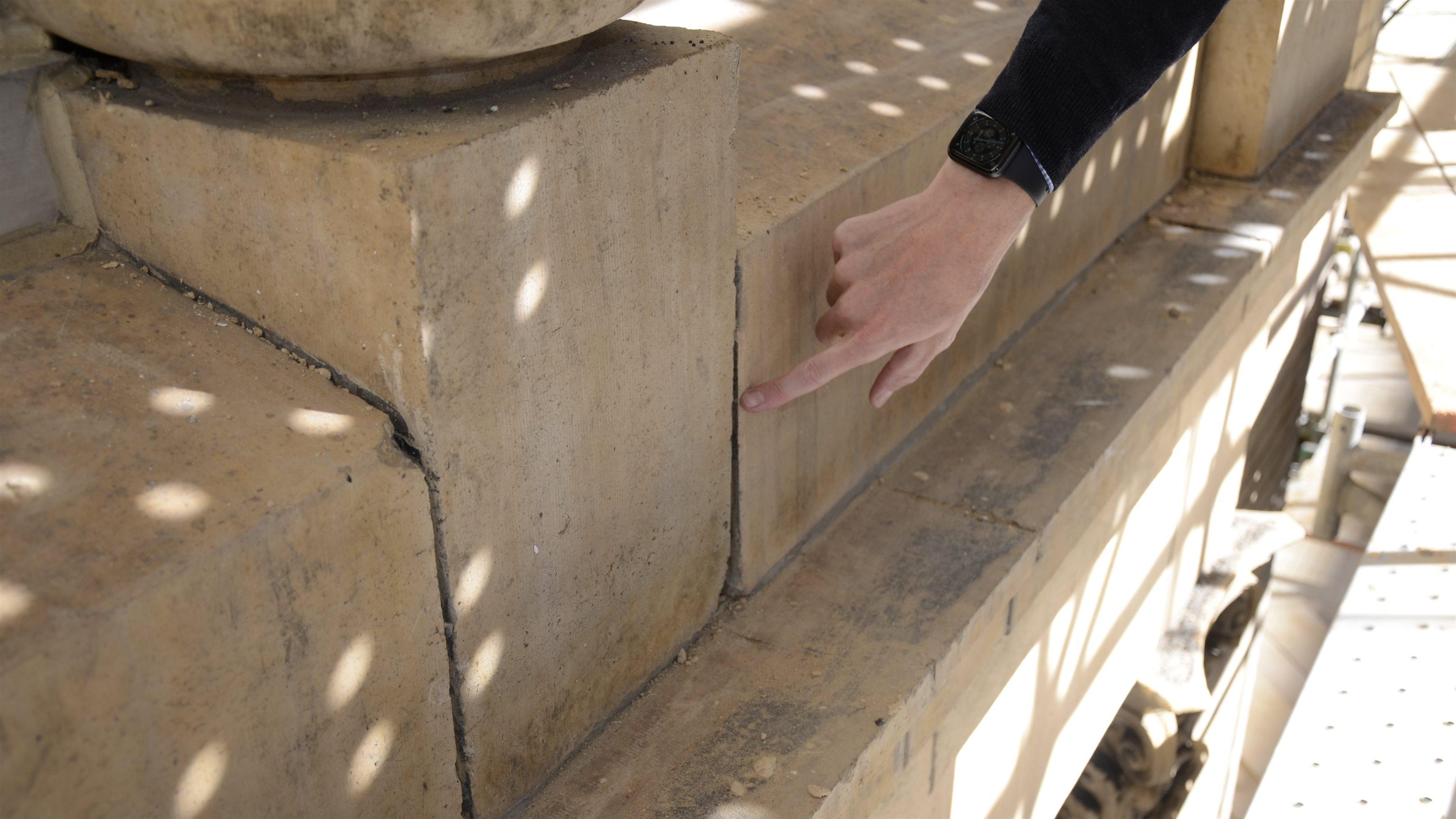 Colton Heimer points out a joint in the terra cotta.