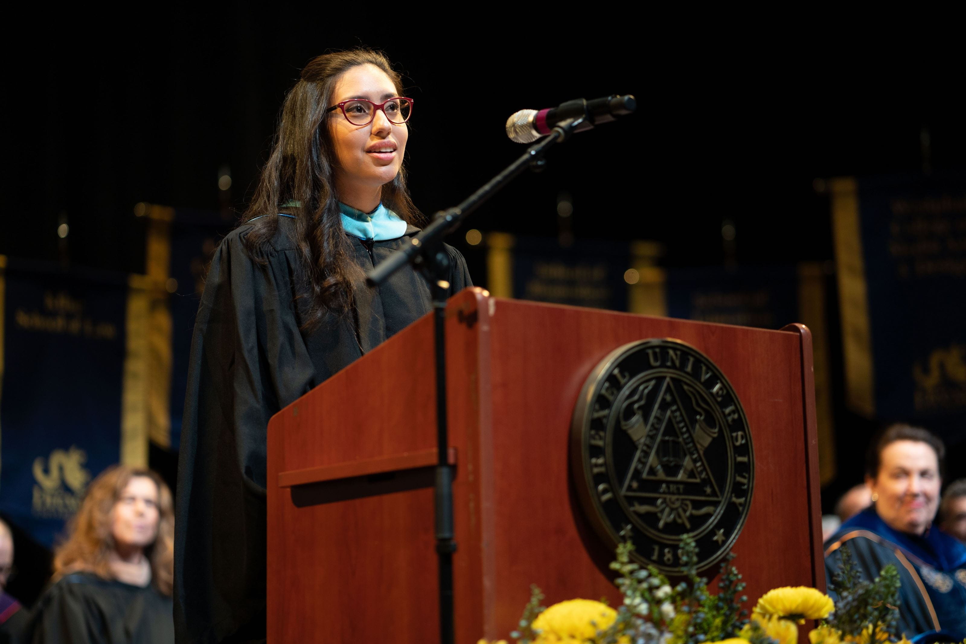María José Garcia stands at the podium at Drexel's 2022 Convocation ceremony.
