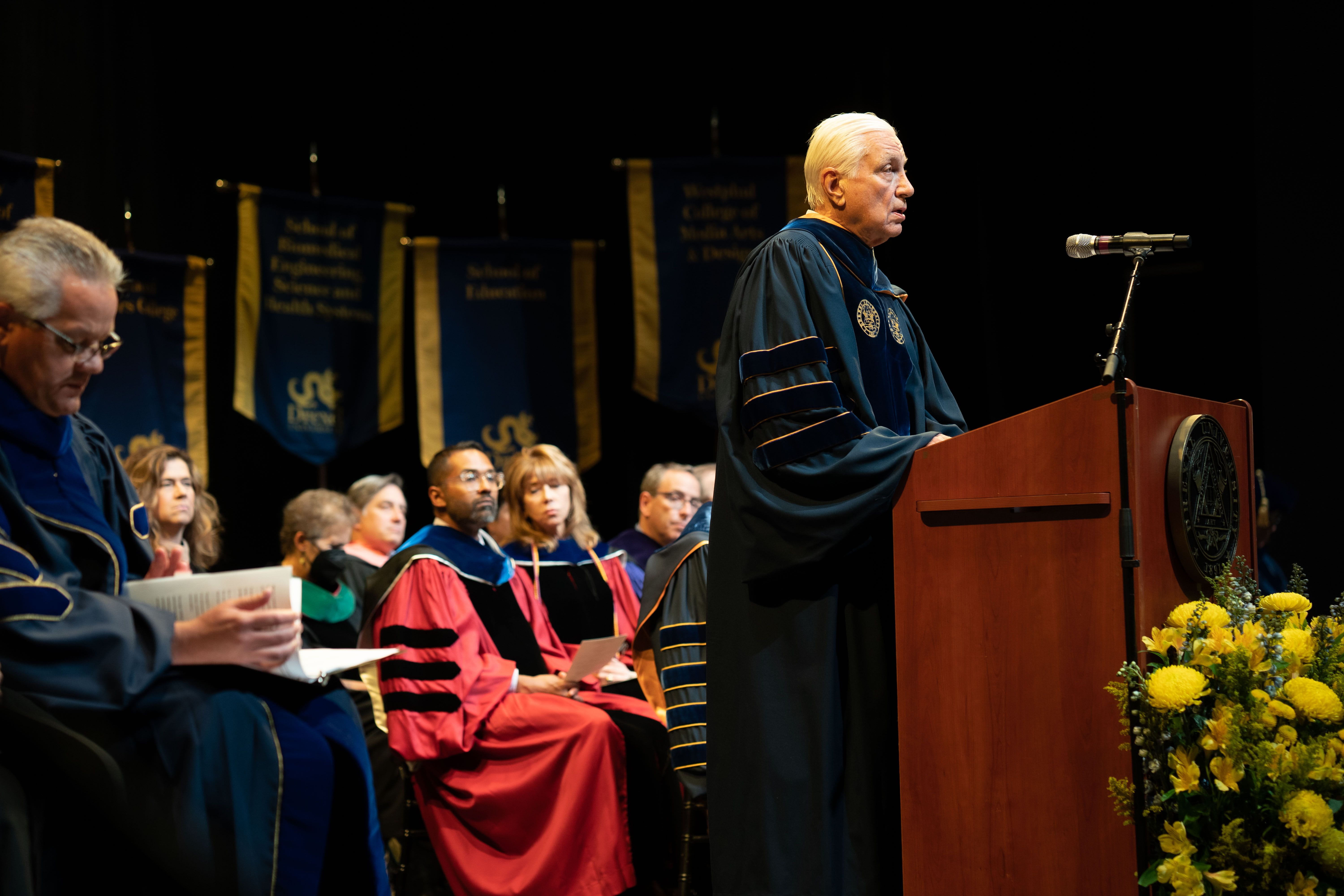 Richard A. Greenawalt stands at the podium at Drexel's 2022 Convocation ceremony.