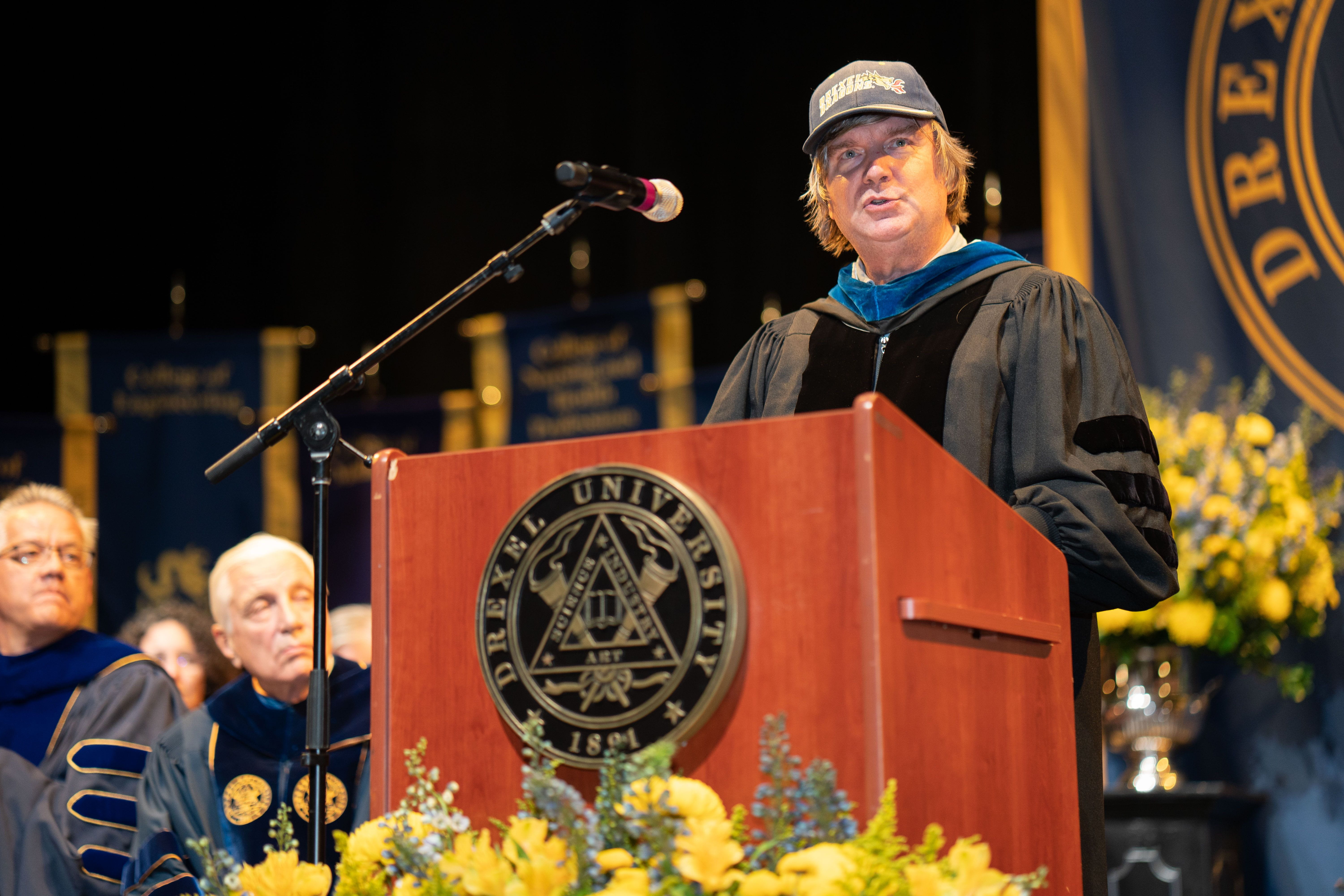 Kevin Owens stands at the podium at Drexel's 2022 Convocation ceremony. Photo credit: Shira Yudkoff Photography.