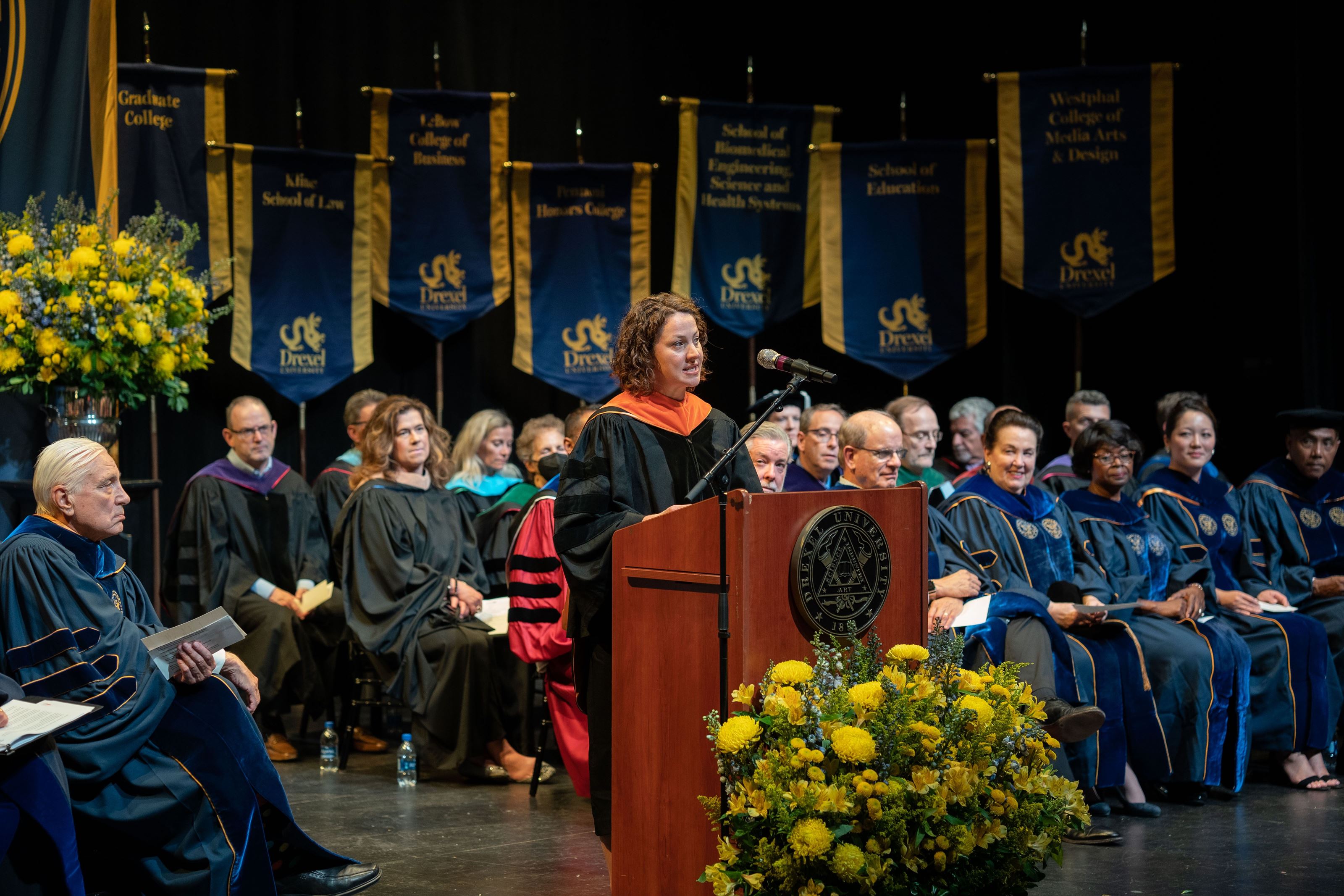 Kara Spiller stands at the podium at Drexel's 2022 Convocation ceremony. Photo credit: Shira Yudkoff Photography.