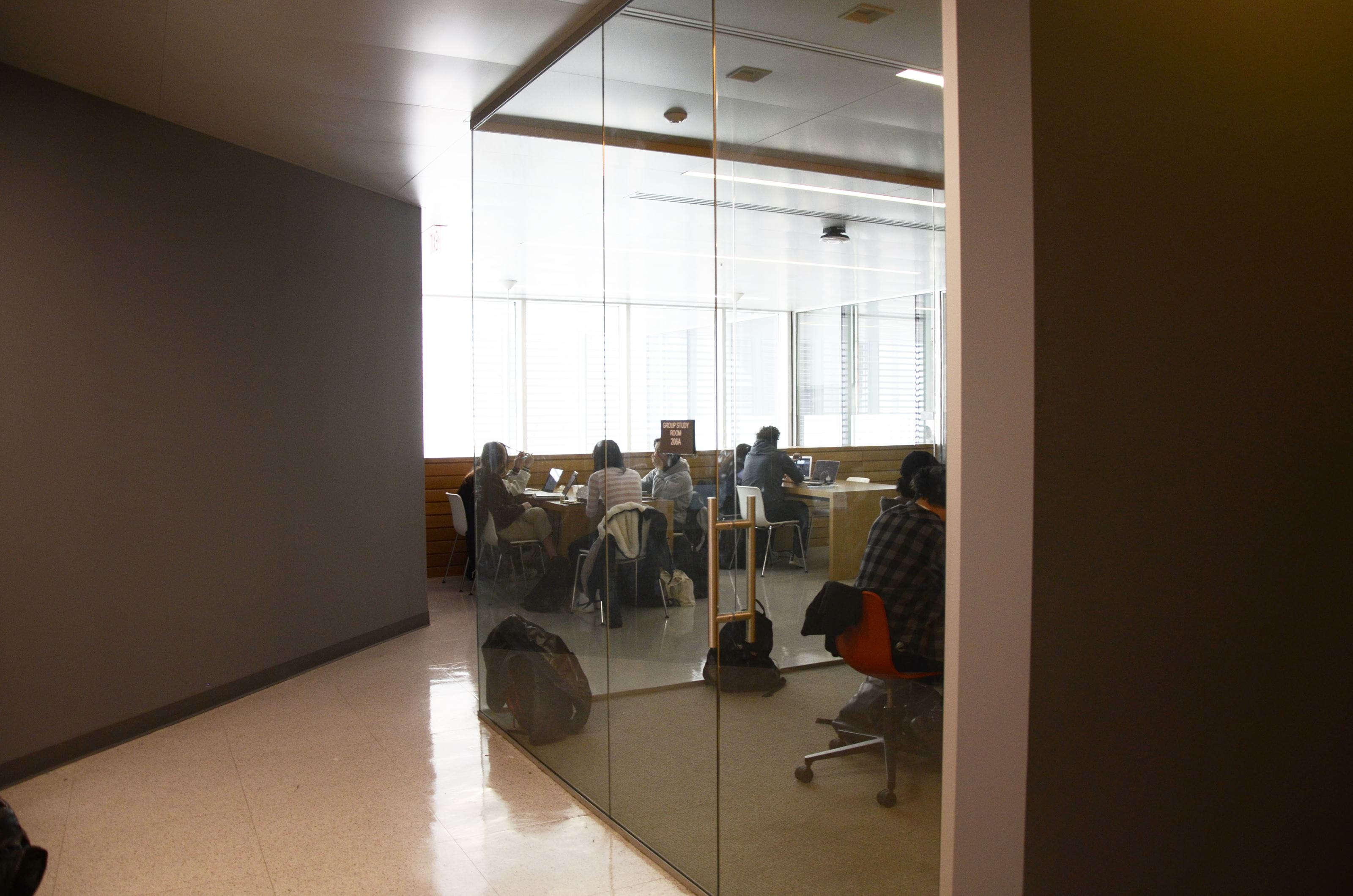 A group study room and tables and chairs located on the second floor.