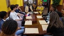 Students discussing African small businesses in West Philly with AFRICOM President and Chief Operating Officer, Eric Edi, PhD, and Youma Bah, a Senegalese entrepreneur, at Bah&#39;s Kilimandjaro restaurant at 45th Street and Baltimore Avenue. Photo credit: Parfait Kouacou, PhD.