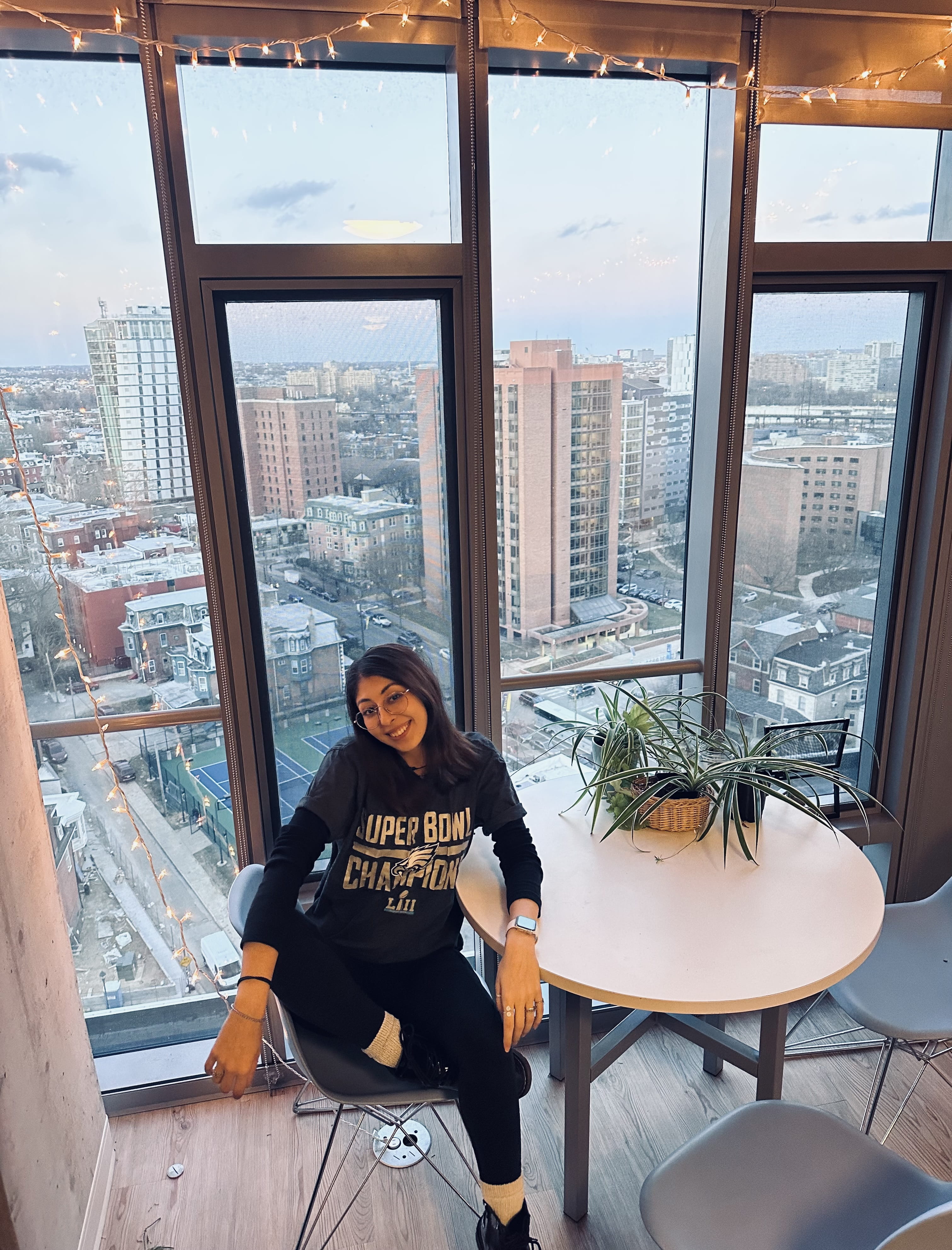 Andreea Buzatu poses in an Eagles shirt overlooking West Philadelphia.