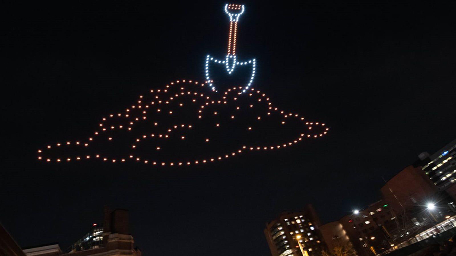 Photo of shovel with drones in night sky