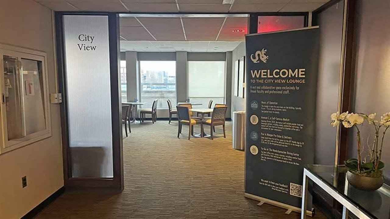 The entrance to the City View Lounge, with a sign announcing the space and a doorway showing the entrance to the dining area.