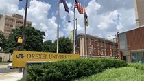 Drexel University sign with greenery and flags