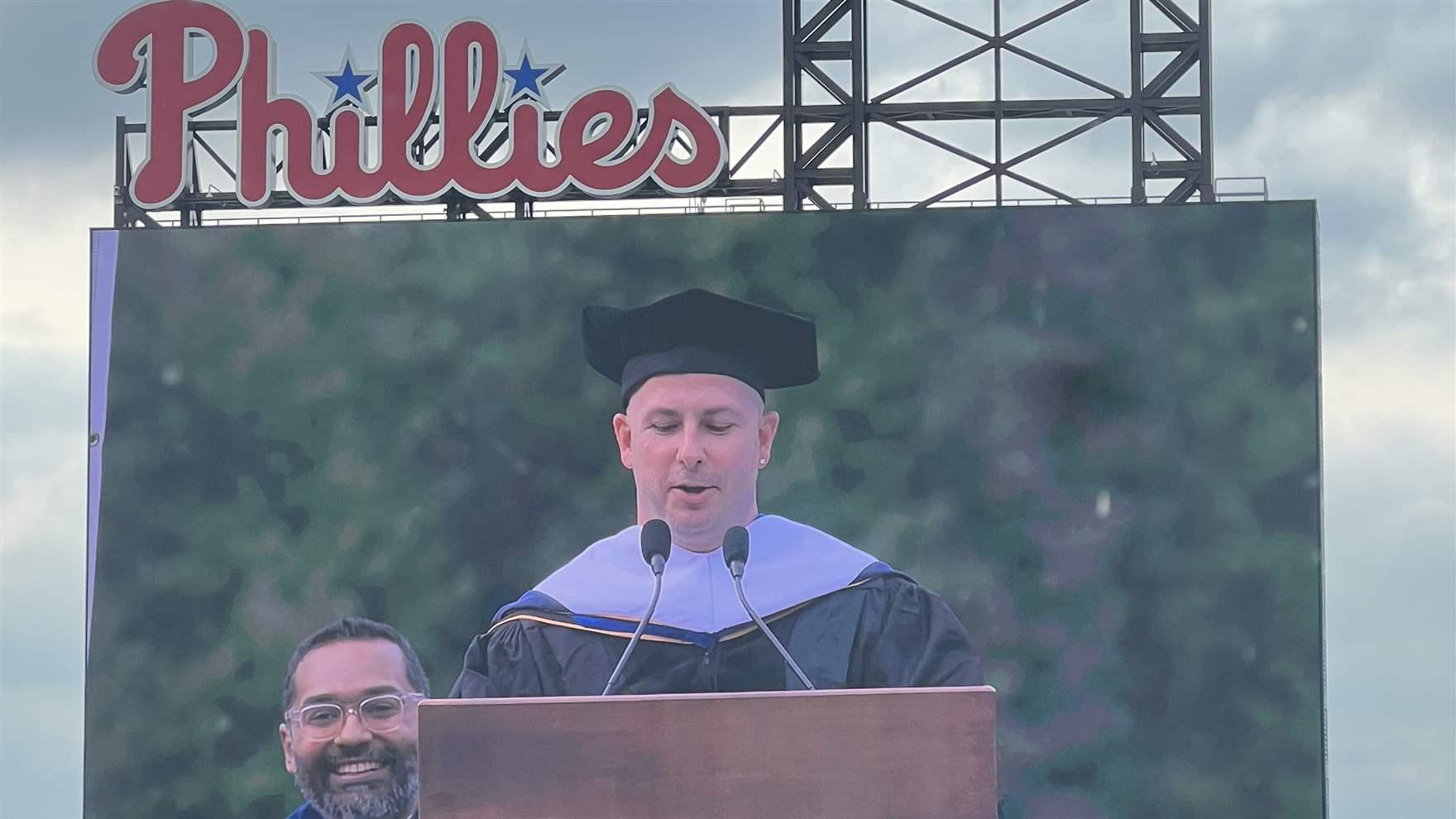 Yannick Nezet-Seguin speaking, shown on the video board at citizens bank park.
