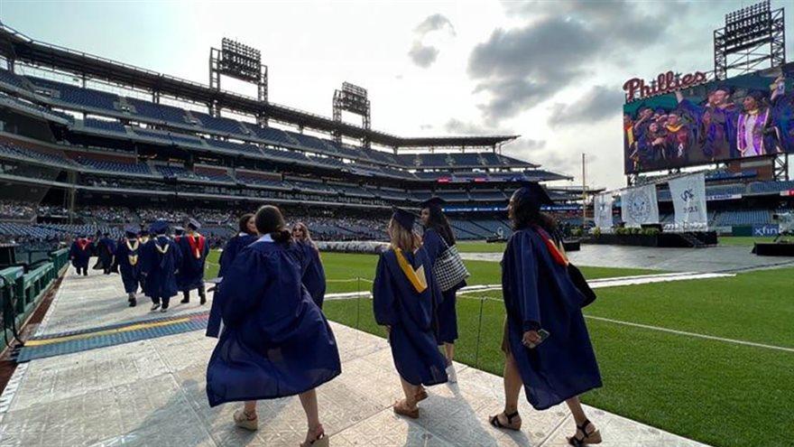Students walk on the field at Citizens Bank Park for Drexel&#39;s Commencement.