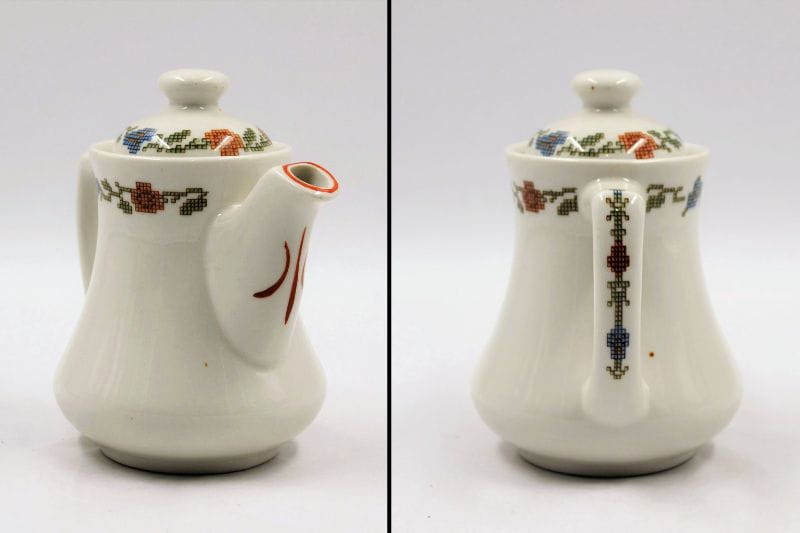 Small single-serving restaurant teapot with lid, white ceramic with foliate designs in form of sampler stitches, from Whitman's Retail Store on Chestnut Street in Philadelphia (the building is still there but the store is long closed).