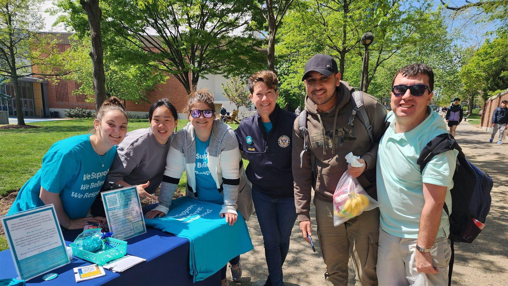 Victim Services Coordinator Amy Spiller posing with students and staff at Teal Tuesday, an event held for Sexual Assault Awareness Month on Drexel’s campus