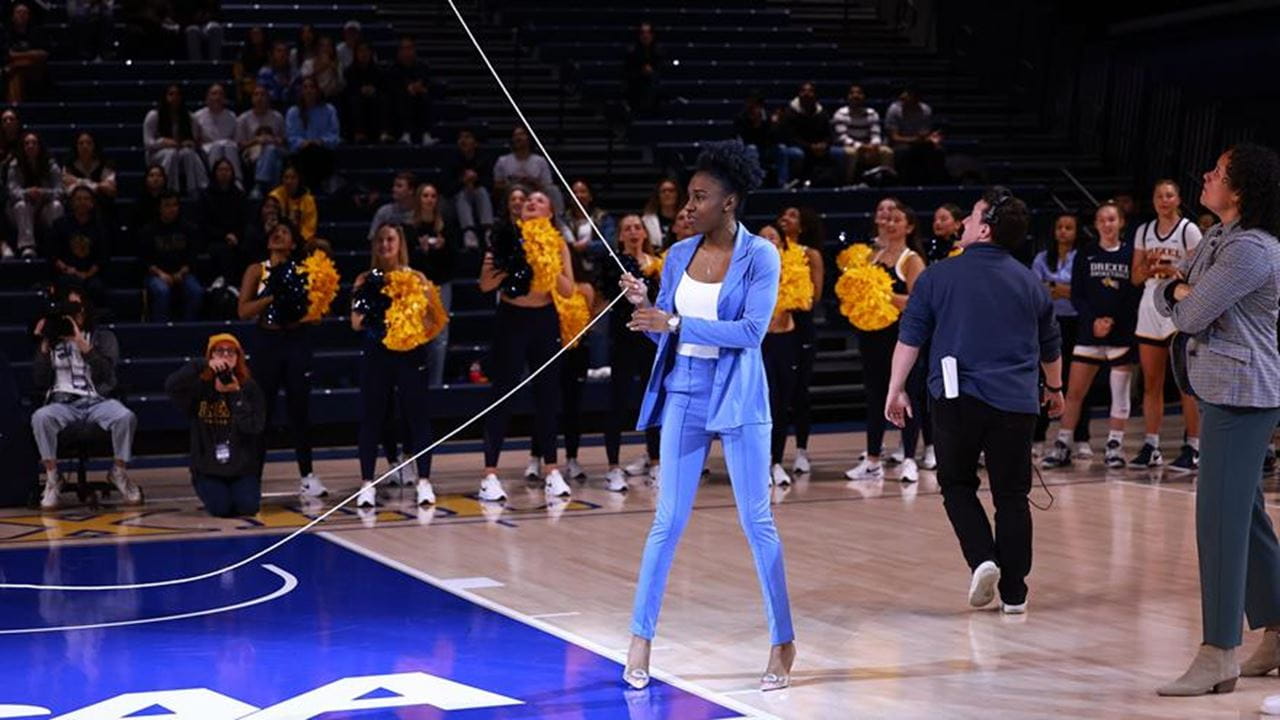 Keishana Washington hoists her jersey into the rafters at the Daskalakis Athletic Center.