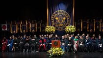 The stage at convocation with speakers, trustees and drexel banners