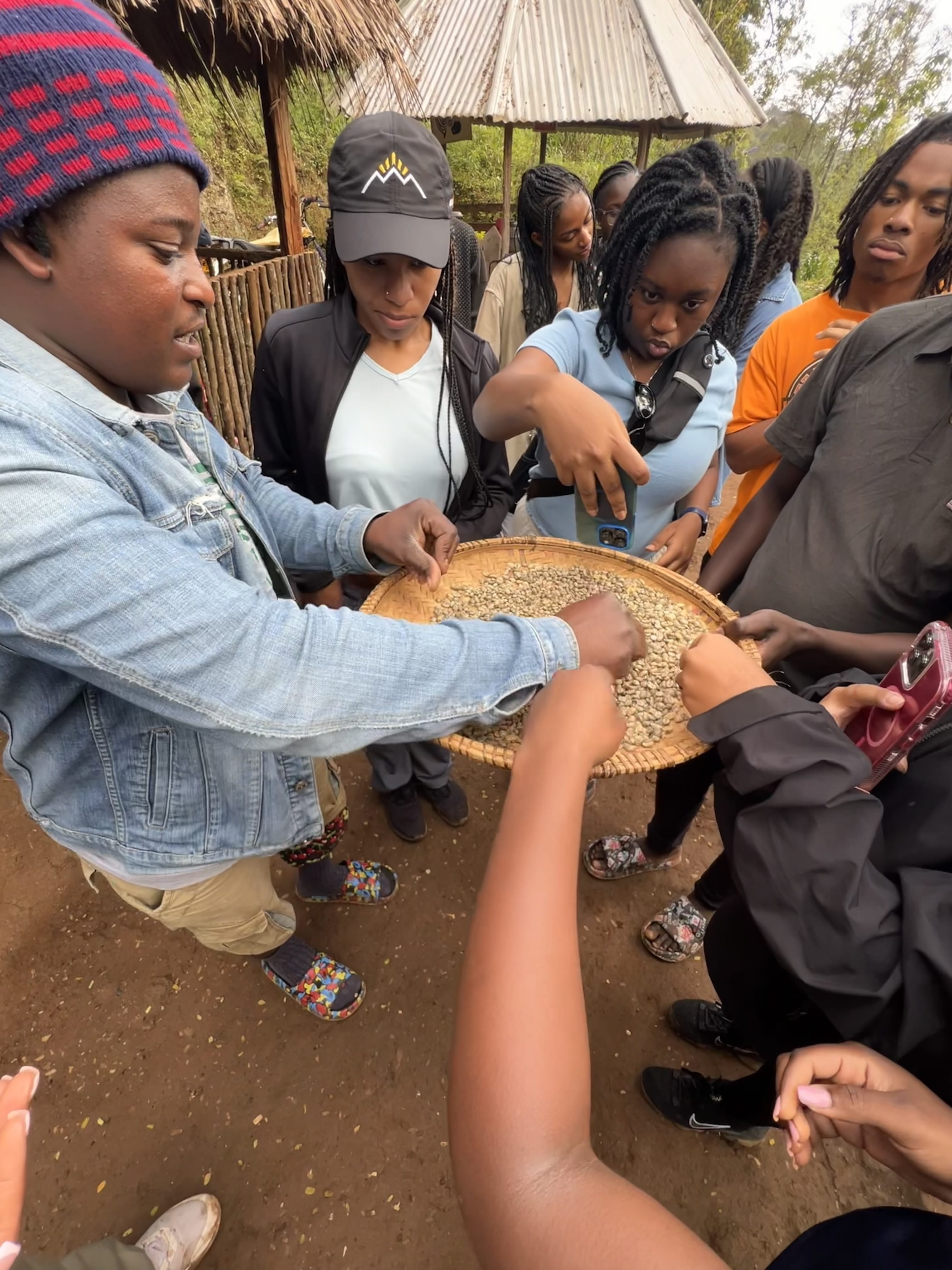 A person holds a bowl of food that people are trying.
