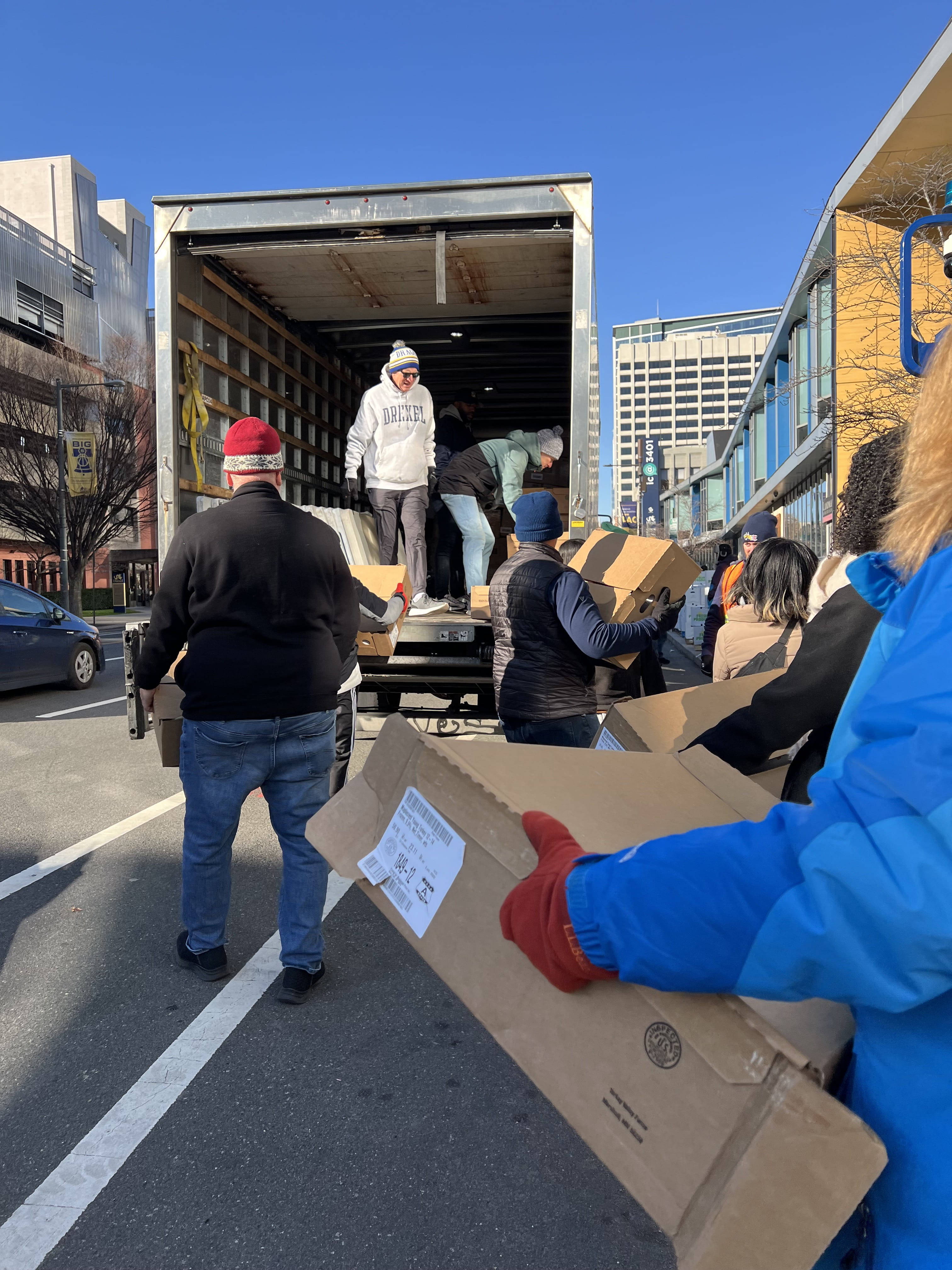 Dragons loading boxes into a truck for distribution.