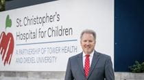 Outgoing CEO Don Mueller in front of the hospital.