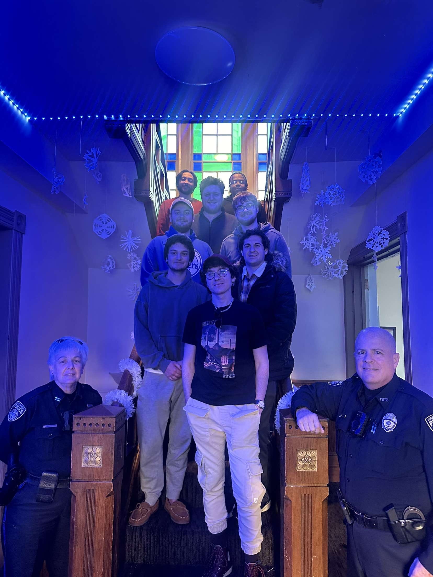 Peple standing together in a room.