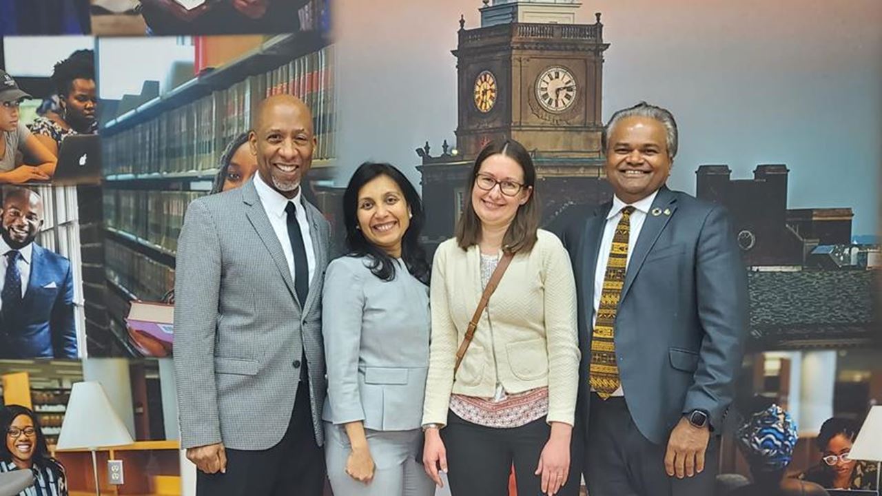 Four people standing in a line 