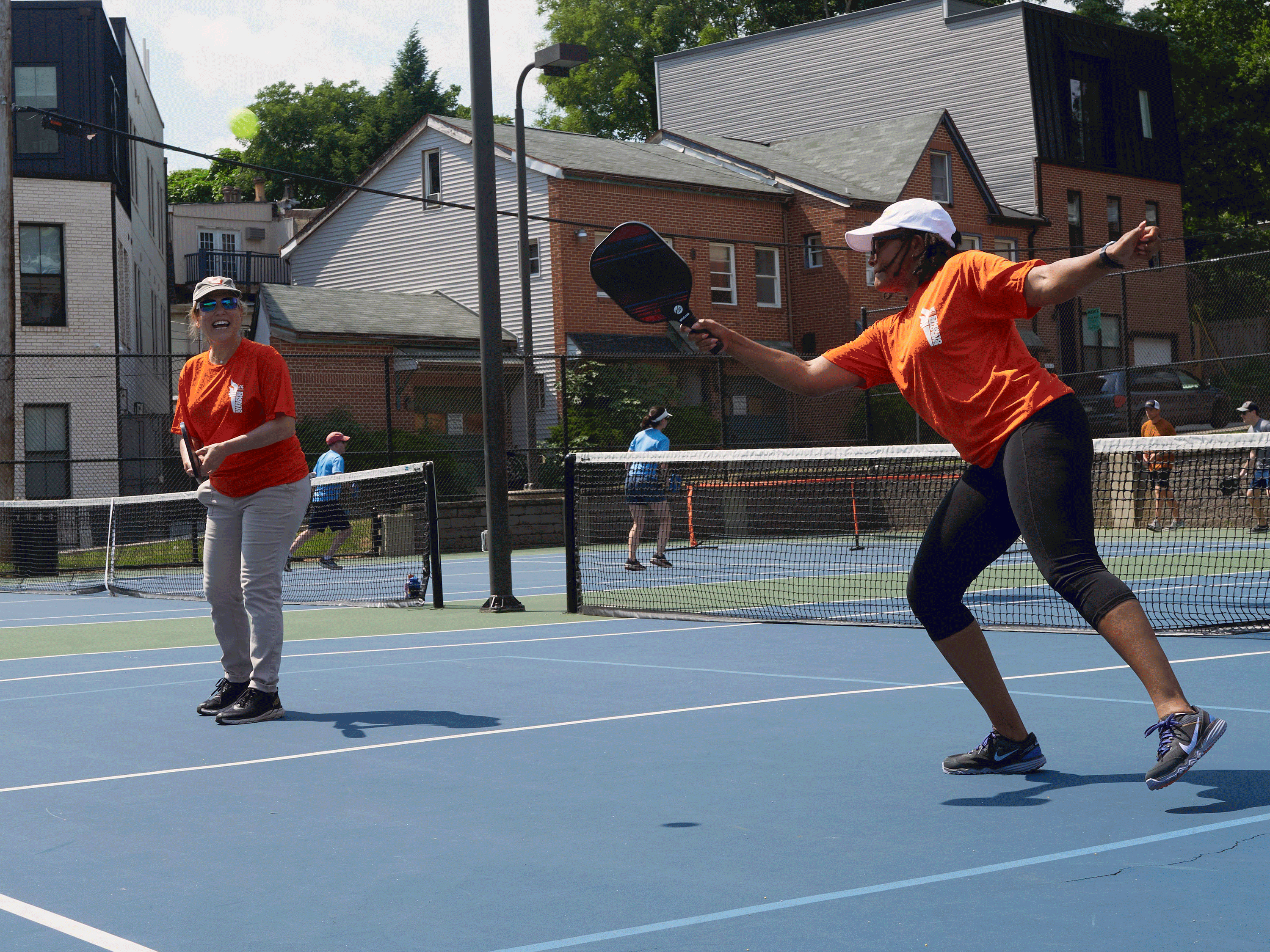 GIF of photos of peopel walking, playing pickleball, shooting a basketball, lined up to play baggo.