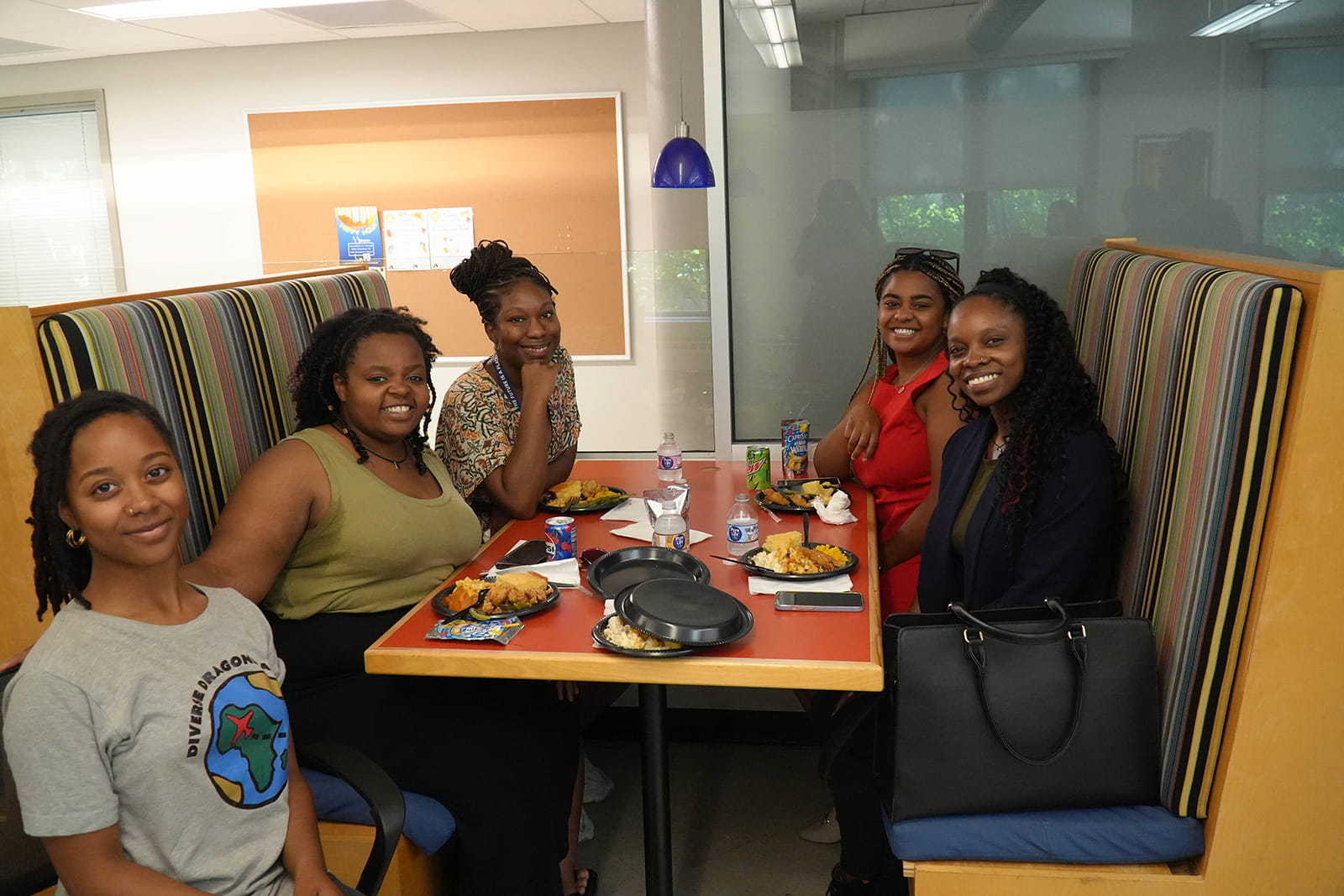 Dragons enjoying the food at a table inside the Center for Black Culture.