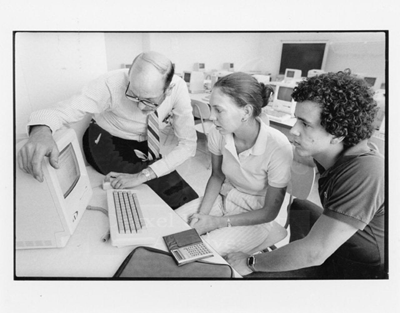 A professor using a computer as students watch. Photo courtesy Drexel University Archives.