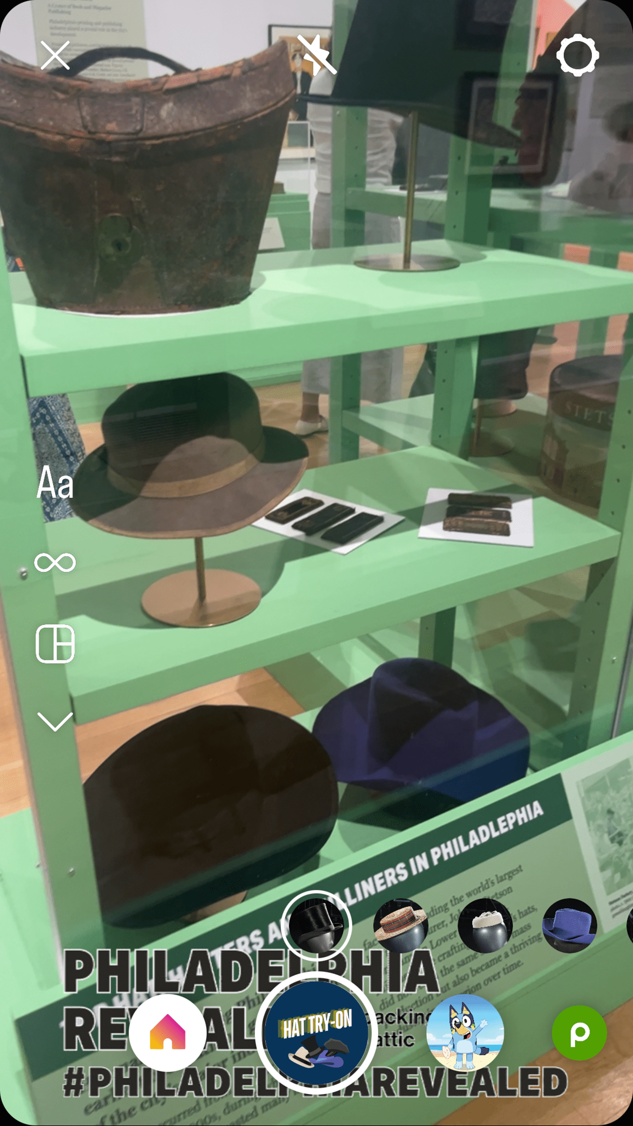 A screenshot showing how the Drexel Instagram filter appears for users to virtually try on hats from the exhibition.