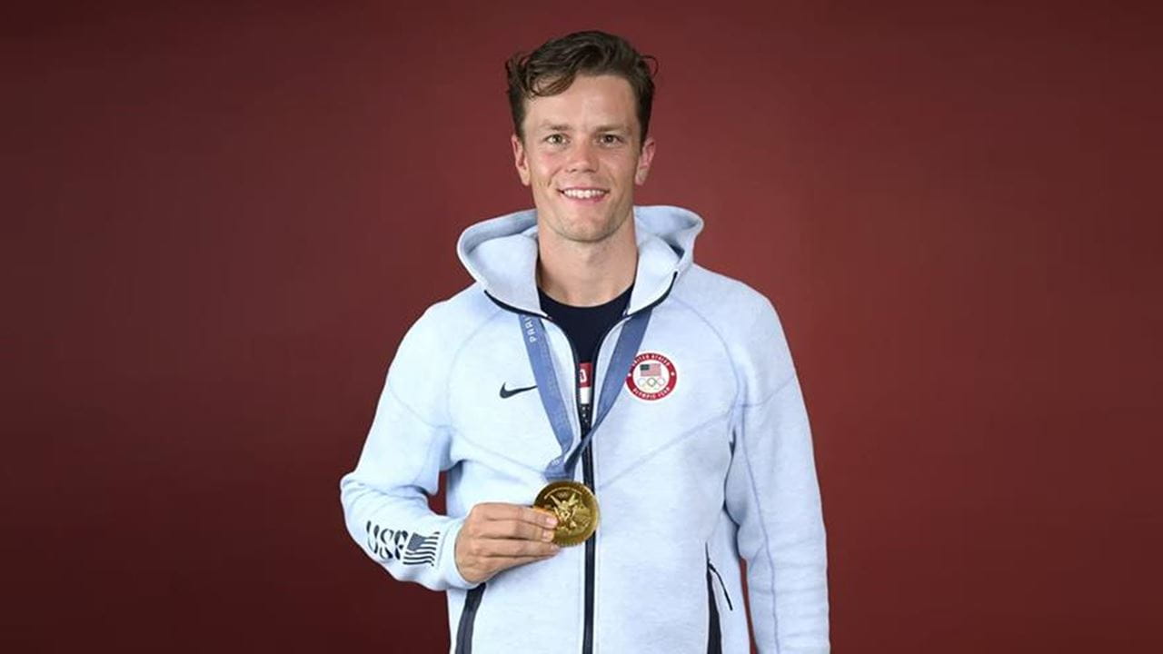 Photo of Justin Best holding 2024 Olympic Gold Medal