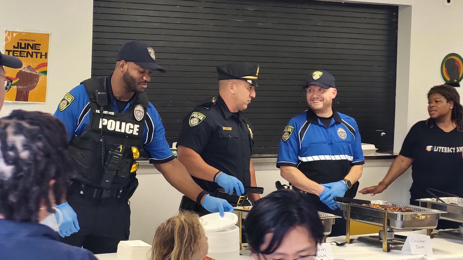 DPS officers serving food at a table.